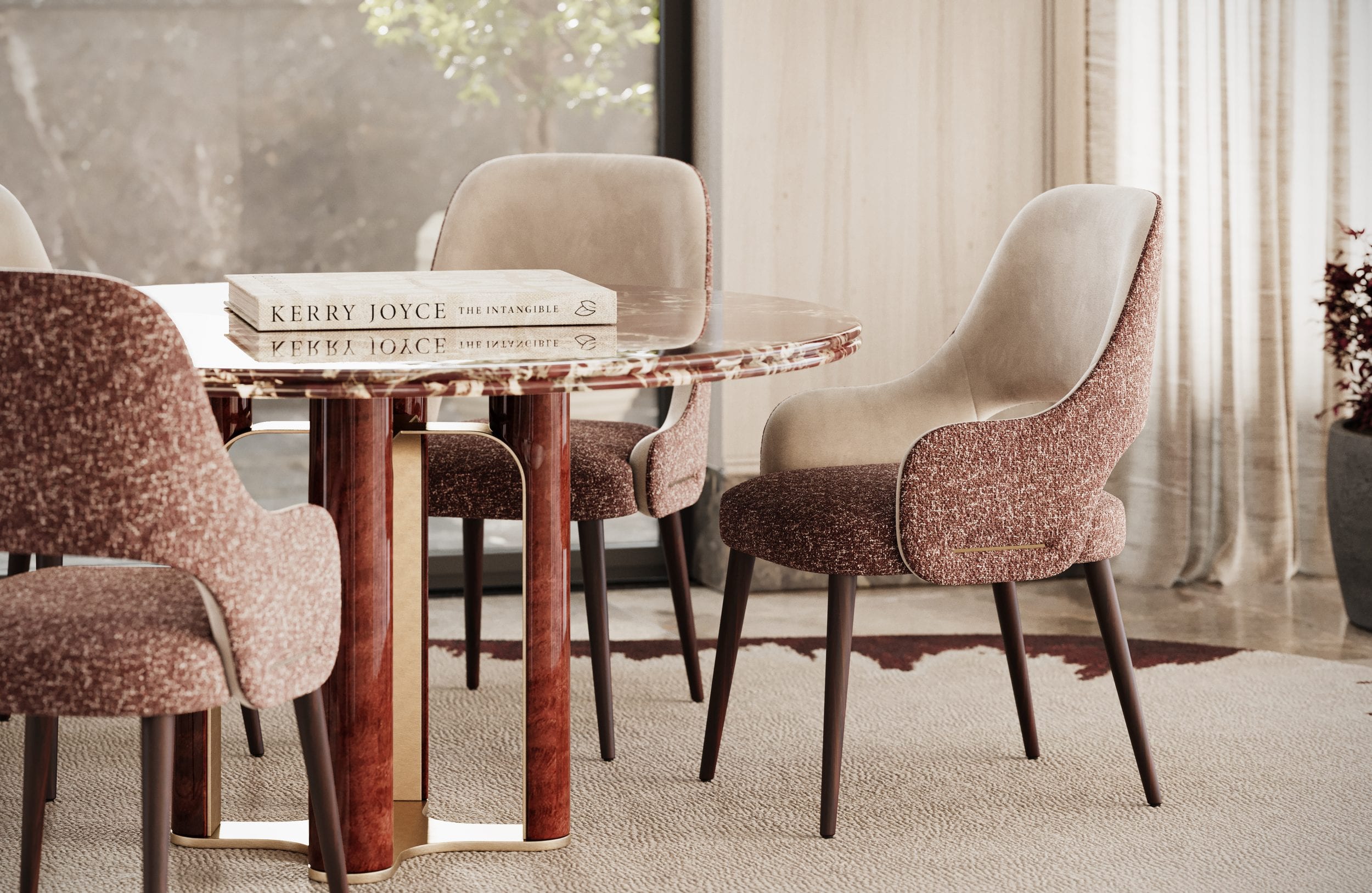 Chairs in rose bouclé and ivory drawn up to a red marble table on a woven rug